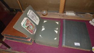A collection of four albums of postcards