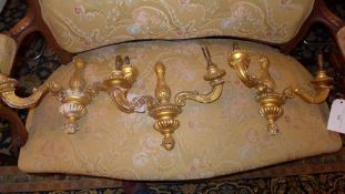 A pair of carved giltwood two branch wall sconces and a similar (A/F)