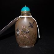 A Chinese reverse painted snuff bottle decorated with birds