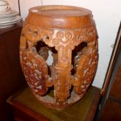 A Chinese hardwood barrell form stool with profusely carved and pierced decoration
