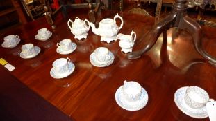 A blue and white porcelain tea set decorated with a foliate pattern to seat eight