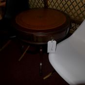 A mahogany and leather lined drum table fitted two drawers and raised on column and triform