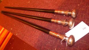 Three ebonised walking canes with silver plated mounts