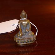 A miniature bronze figure of a seated Buddha