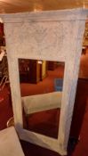 A pier mirror in distressed grey finish frame with foliate decoration in relief