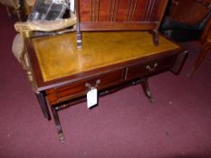A mahogany twin flap low table with leather lined top and fitted two drawers