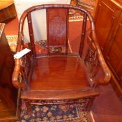 A pair of Chinese rosewood bamboo style armchairs with solid seats and star form decoration on the