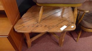 An oak diamond shaped low table raised on stretchered supports