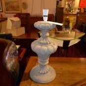 A carved wooden table lamp in working order