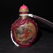 A Chinese Peking glass snuff bottle with landscape pictorial reserves