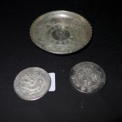 A Chinese white metal coin dish together with two white metal coins