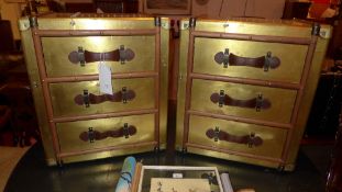 A pair of gold metal chests fitted three drawers with leather strap handles