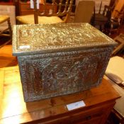 A brass clad log bin with social scenes in relief