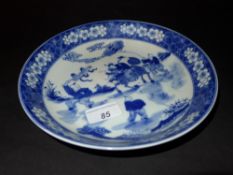 A Chinese blue and white shallow dish decorated with pictorial reserves
