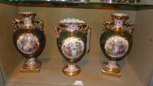 A set of three C19th twin handled vases decorated with pictoral reserves and heightened in gilt
