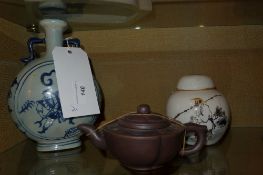 A Chinese terracotta tea pot together with a covered jar and a blue and white moon flask ( 3 )