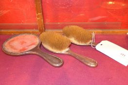 A three piece hallmarked silver dressing table set
