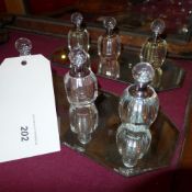 A collection of glass perfume bottles with two mirrored trays