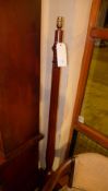 A mahogany standard lamp of reeded form and raised on triform supports