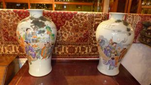 A pair of Chinese vases of large size decorated with social scene pictorial reserves