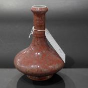 A Chinese vase glazed in mottled purple and with circular mark to the base