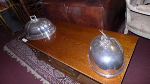 A silver plated food cover and a similar