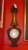 A 1940's carved oak aneroid berometer