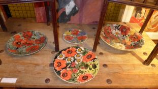 A collection of three large Moorcroft style chargers and a plate