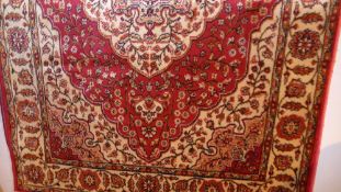 A Persian Kilim design runner the rouge field with extensive gold floral decoration in a triple
