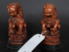 A pair of Chinese resin figures of Kylin raised on circular base