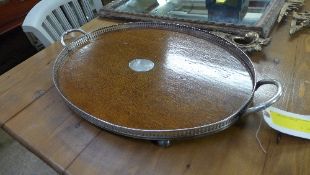 An Edwardian oak oval tray silver plated pierced gallery and carrying handles