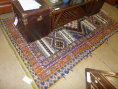 A Moroccan rug the blue ground with central pole medallion within multi border