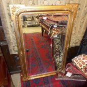 A gilt wall hanging mirror with bevelled