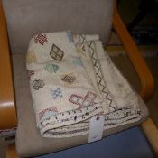 A hand knotted wool rug the beige grand