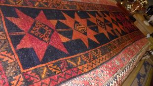 A hand knotted Kazak runner the pole med