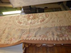 A large Aubusson carpet the fawn ground
