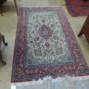 A hand knotted Isfahan Persian rug the red ground with central motifs multi border