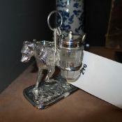 A silver plated cruet on dog stand