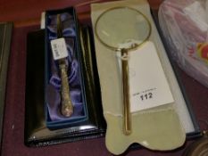 A gilt metal magnifying glass, silver ha