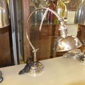 A silver plated desk with adjustable shade