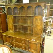 A C20th oak dresser the open plate rack