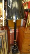 An ebonised and parcel gilt standard lam