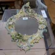 A pair of Italianate porcelain pier mirrors with painted decoration and circular plates