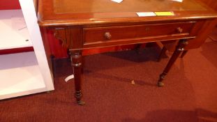 A Victorian mahogany writing table with lined top above single drawer and raised on turned supports