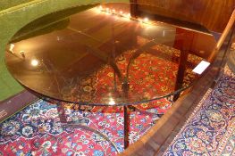 A Merrow Associates centre table with circular smokey glass top