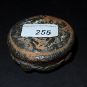 An antique earthenware jar and cover decorated with cherubs