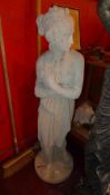 A stoneware garden statue of a maiden