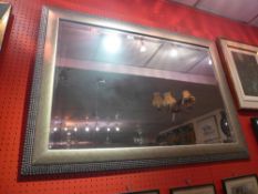 A wall mirror with bevelled rectangular plate within silvered frame