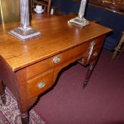 A 19th Century oak lowboy fitted four drawers with brass handles and raised on turned supports