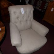 A pair of C19th easy chairs upholstered in buttoned grey linen fabric and raised on turned supports